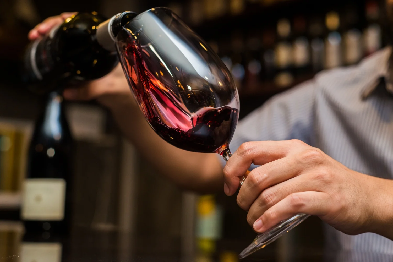 red wine being poured into a wine glass