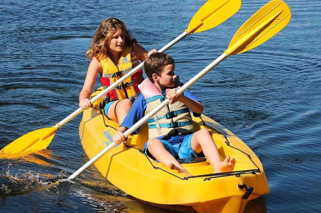 two children kayaking